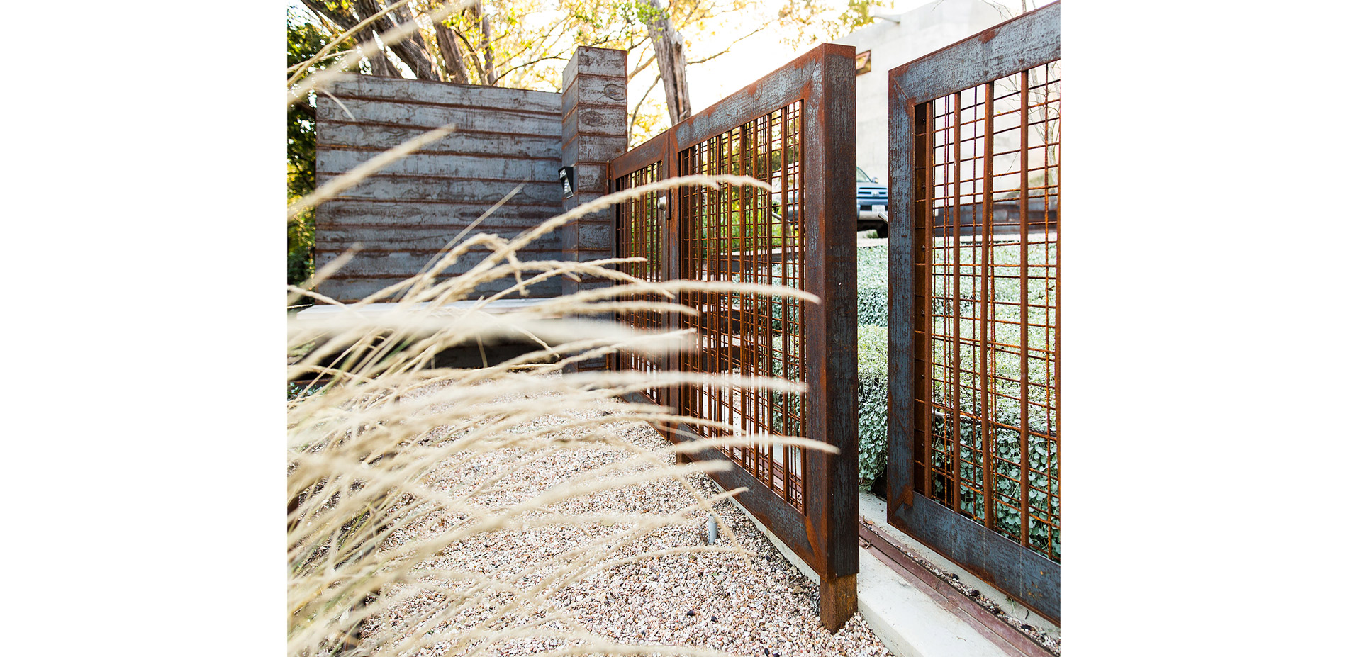 Layers of mesh panels create a pattern of raw steel mesh, providing a warm, transparent entry gate and pool barrier fencing.…
