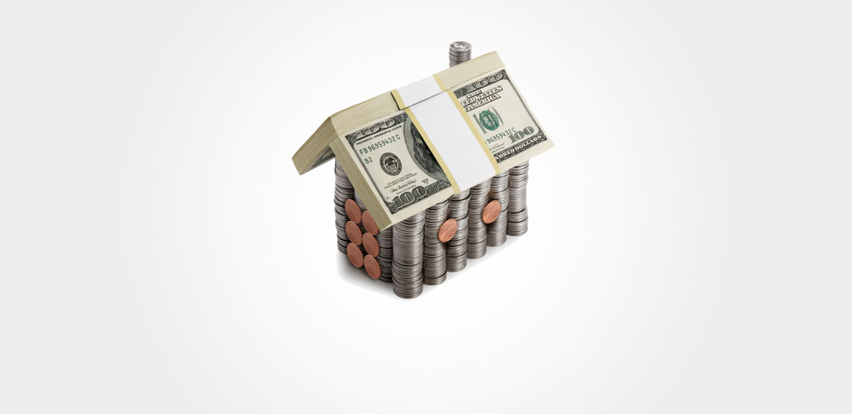 Small model of a house built out of coins and paper bills